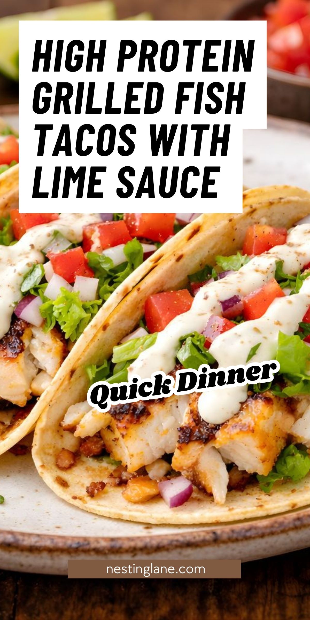 Pinterest pin with close-up grilled fish tacos on corn tortillas, topped with shredded lettuce, diced tomato, red onion, and creamy lime sauce on a plate. Text reads “HIGH PROTEIN GRILLED FISH TACOS WITH LIME SAUCE,” “Quick Dinner,” and “nestinglane.com.”