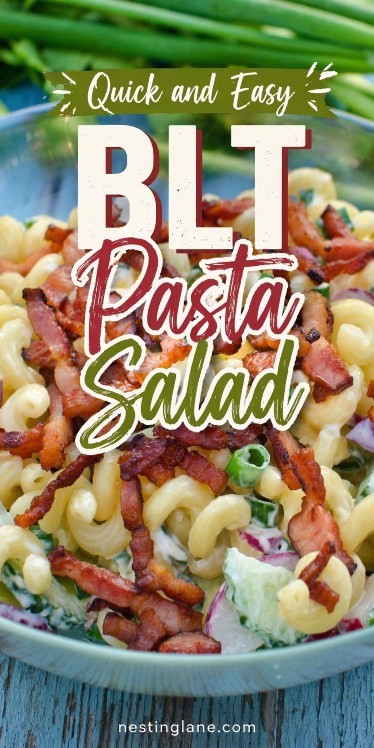 BLT pasta salad with macaroni, crispy bacon, chopped lettuce, green onion, and creamy dressing in a bowl. Text reads: “Quick and Easy BLT Pasta Salad.” Small text at bottom says “nestinglane.com.”