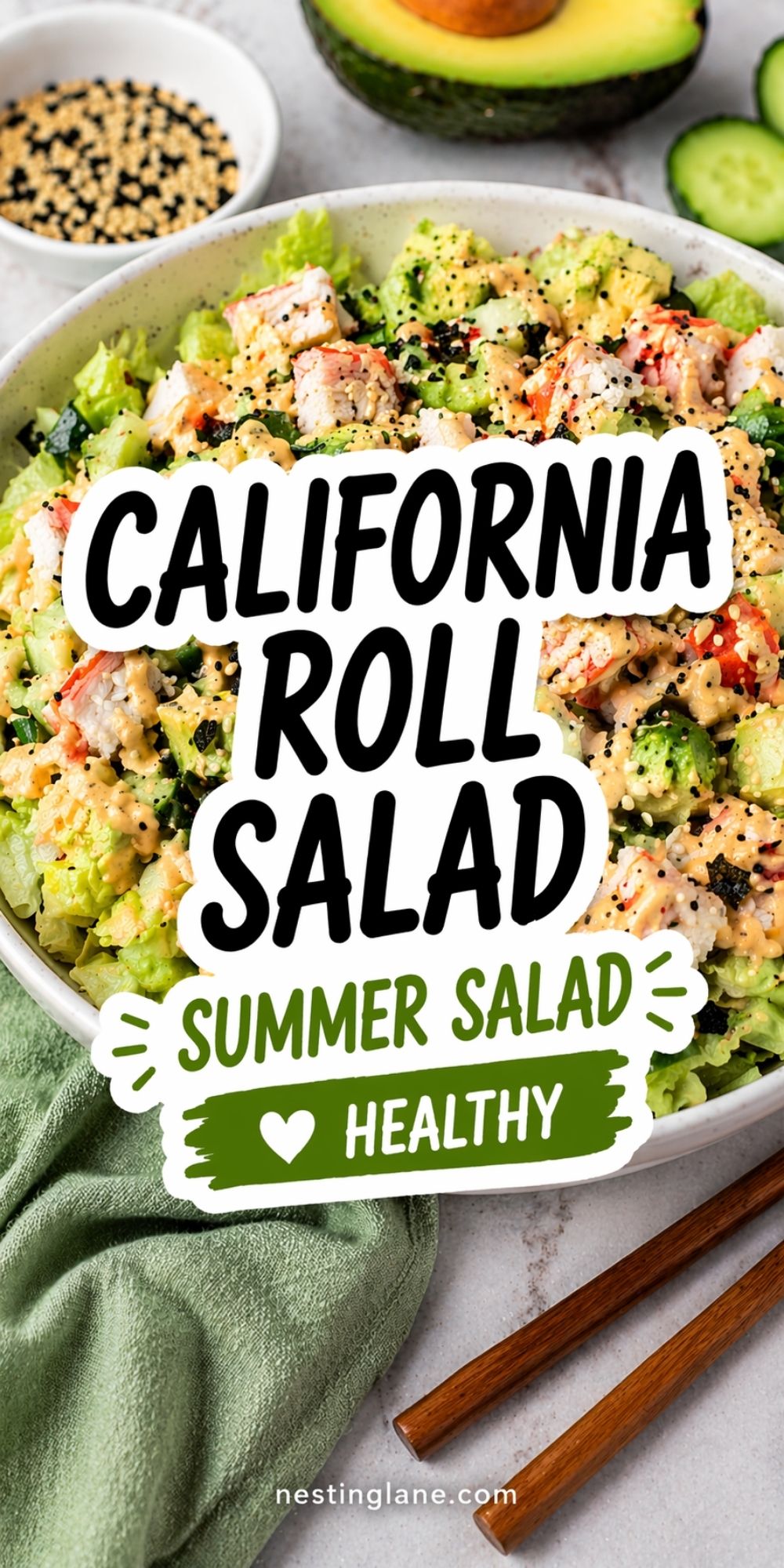 Pinterest pin for California roll salad with crab, avocado, cucumber, lettuce, creamy dressing, and sesame seeds in a bowl, with avocado, sesame, and chopsticks nearby. Text on image says: “CALIFORNIA ROLL SALAD” “SUMMER SALAD” “HEALTHY” and “nestinglane.com”.