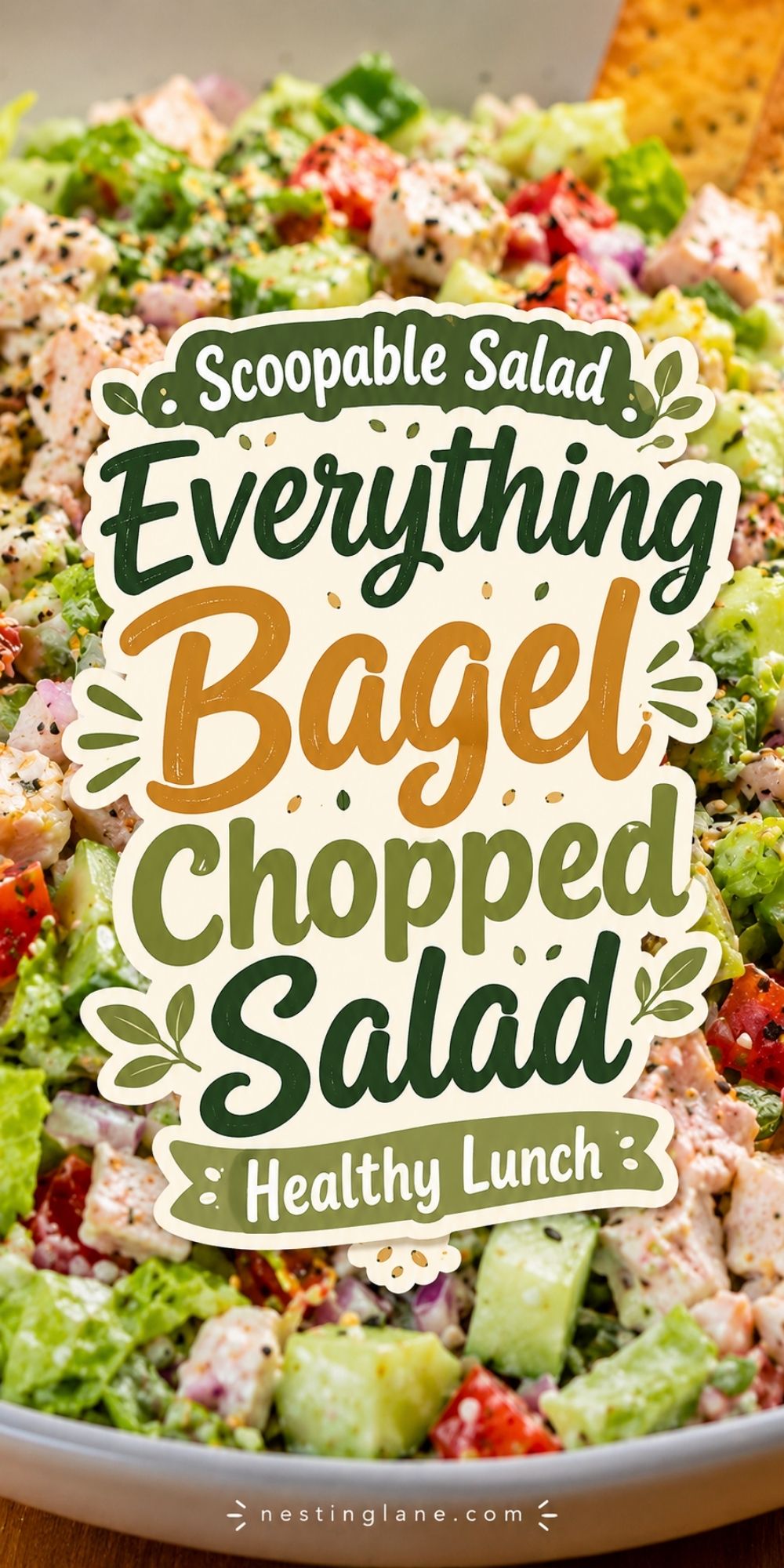 Everything bagel chopped salad with chicken, lettuce, cucumbers, tomatoes, red onion, creamy dressing, and bagel chips. Text reads: “Scoopable Salad Everything Bagel Chopped Salad Healthy High Protein Salad nestinglane.com.”