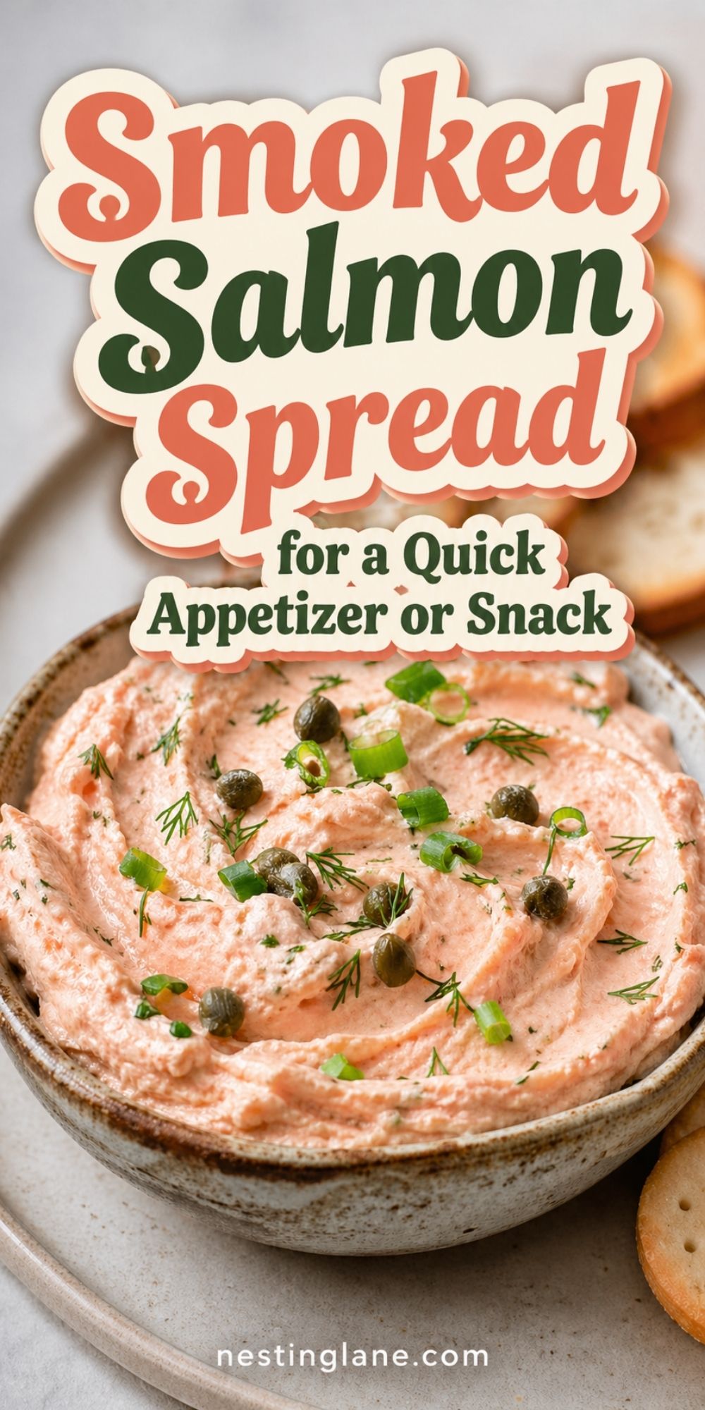 Smoked Salmon Spread in a bowl topped with capers, green onions, and dill, served with crackers. Text reads “Smoked Salmon Spread for a Quick Appetizer or Snack” and “nestinglane.com.”