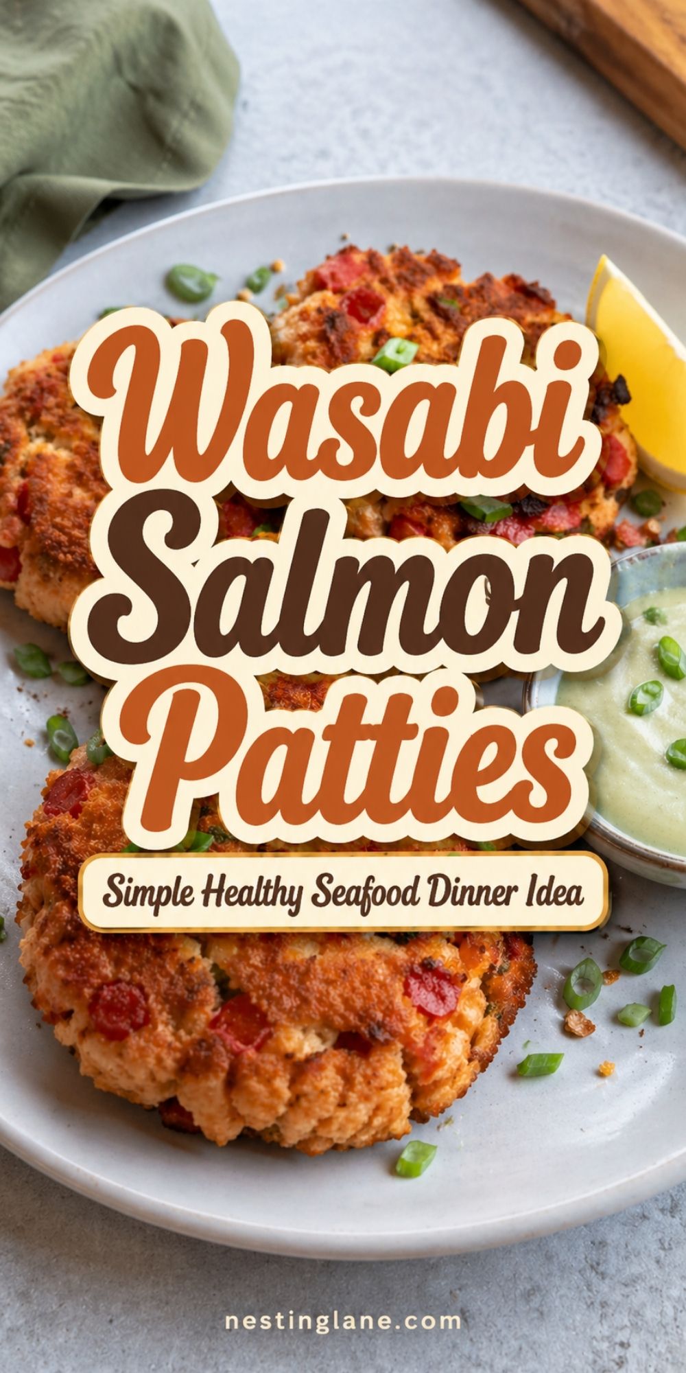 Wasabi Salmon Patties on a plate with green onion, lemon, and creamy dipping sauce. Text reads “Wasabi Salmon Patties,” “Simple Healthy Seafood Dinner Idea,” and “nestinglane.com.”