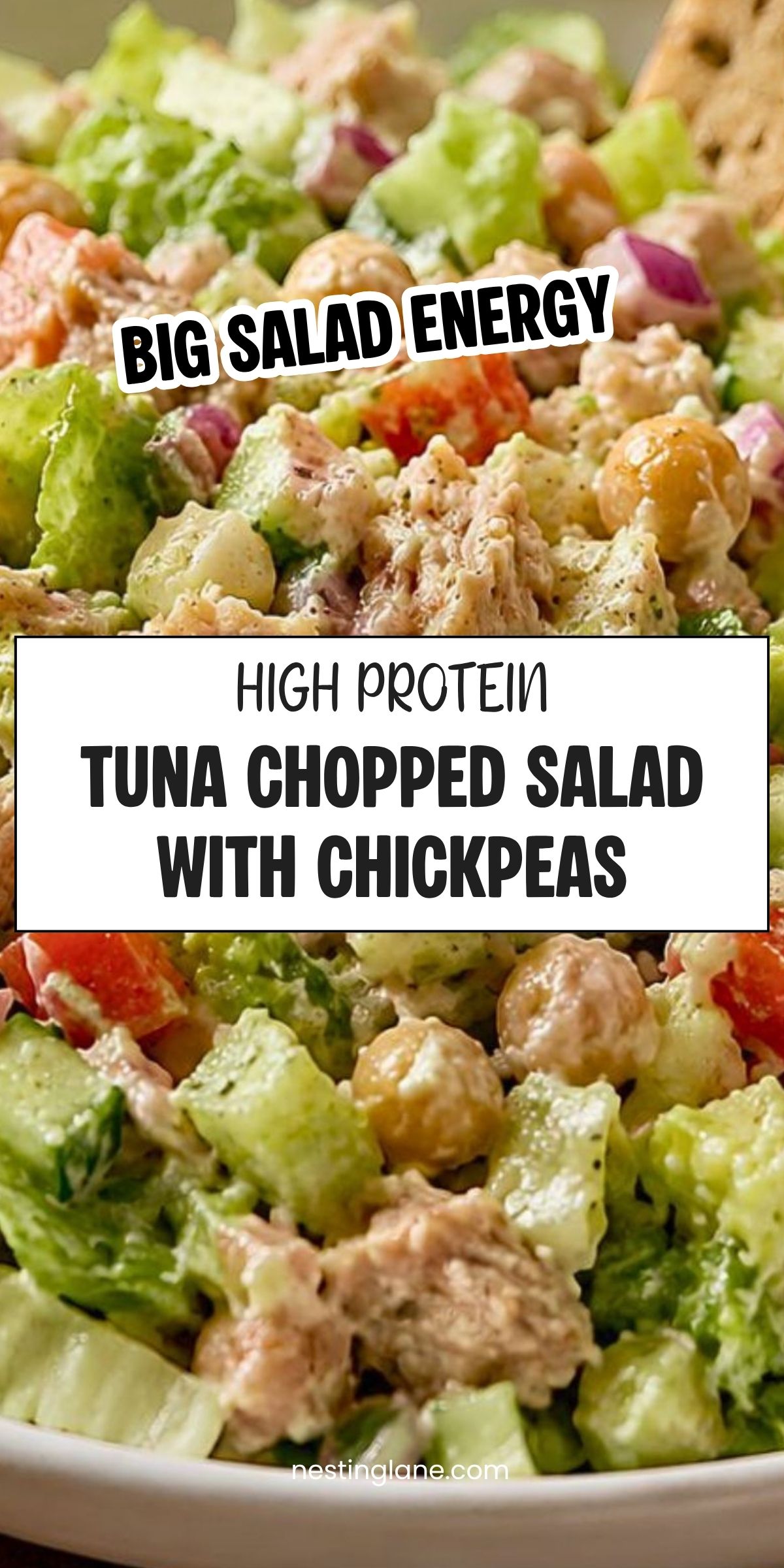High protein tuna chopped salad with chickpeas, lettuce, cucumber, tomatoes, red onion, creamy dressing, and pita chips. Text reads: āBig Salad Energy. High Protein Tuna Chopped Salad with Chickpeas. nestinglane.comā