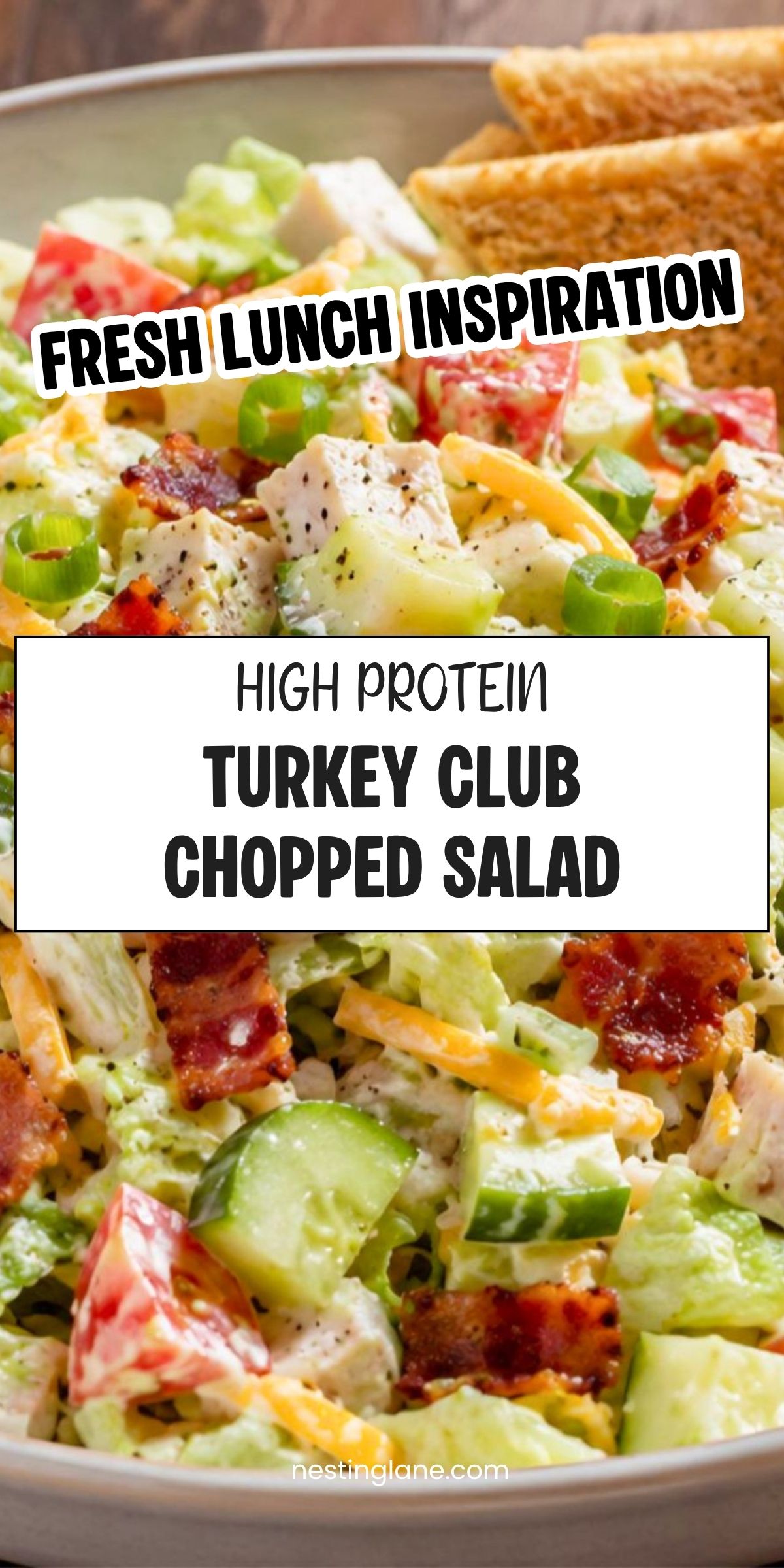 High protein turkey club chopped salad with turkey, bacon, lettuce, tomatoes, cucumber, cheese, green onions, and toast chips. Text reads: āFresh Lunch Inspiration. High Protein Turkey Club Chopped Salad. nestinglane.comā
