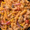 Creamy chicken fajita pasta salad with rotini, diced chicken, black beans, corn, tomatoes, red onion, and creamy Southwest dressing.