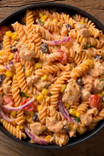 Creamy chicken fajita pasta salad with rotini, diced chicken, black beans, corn, tomatoes, red onion, and creamy Southwest dressing.