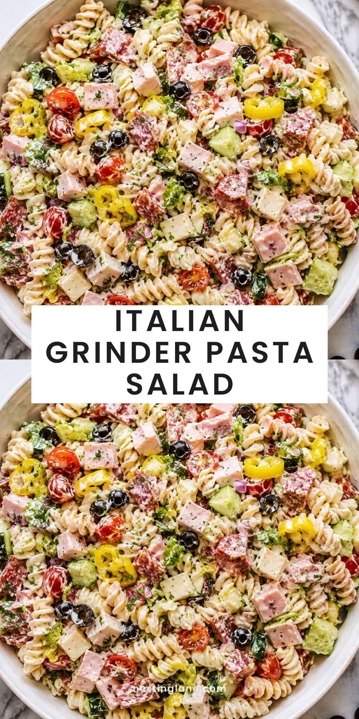 Italian grinder pasta salad with rotini, ham, salami, provolone, cherry tomatoes, cucumber, black olives, banana peppers, romaine, and creamy dressing. Text reads “ITALIAN GRINDER PASTA SALAD” and “nestinglane.com.”
