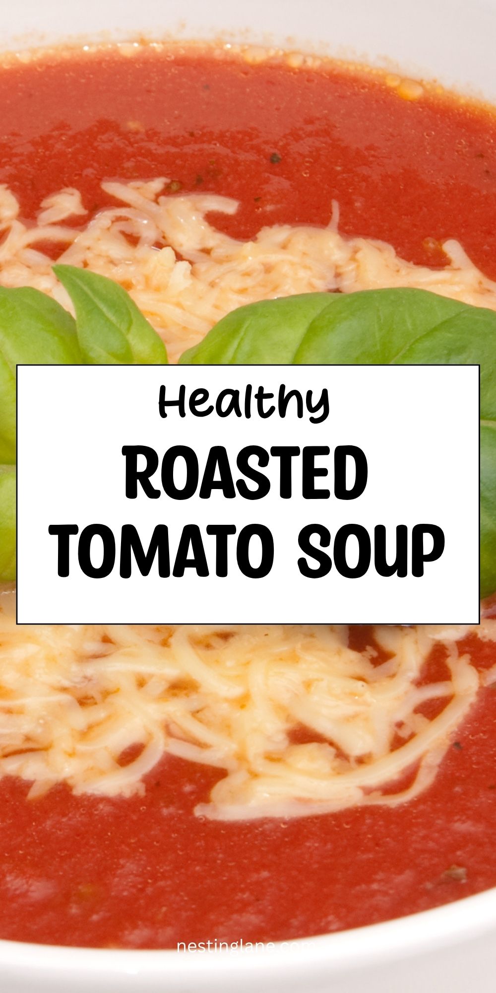 Smooth roasted tomato soup topped with shredded cheese and fresh basil. Text reads “Healthy Roasted Tomato Soup” and “nestinglane.com.”