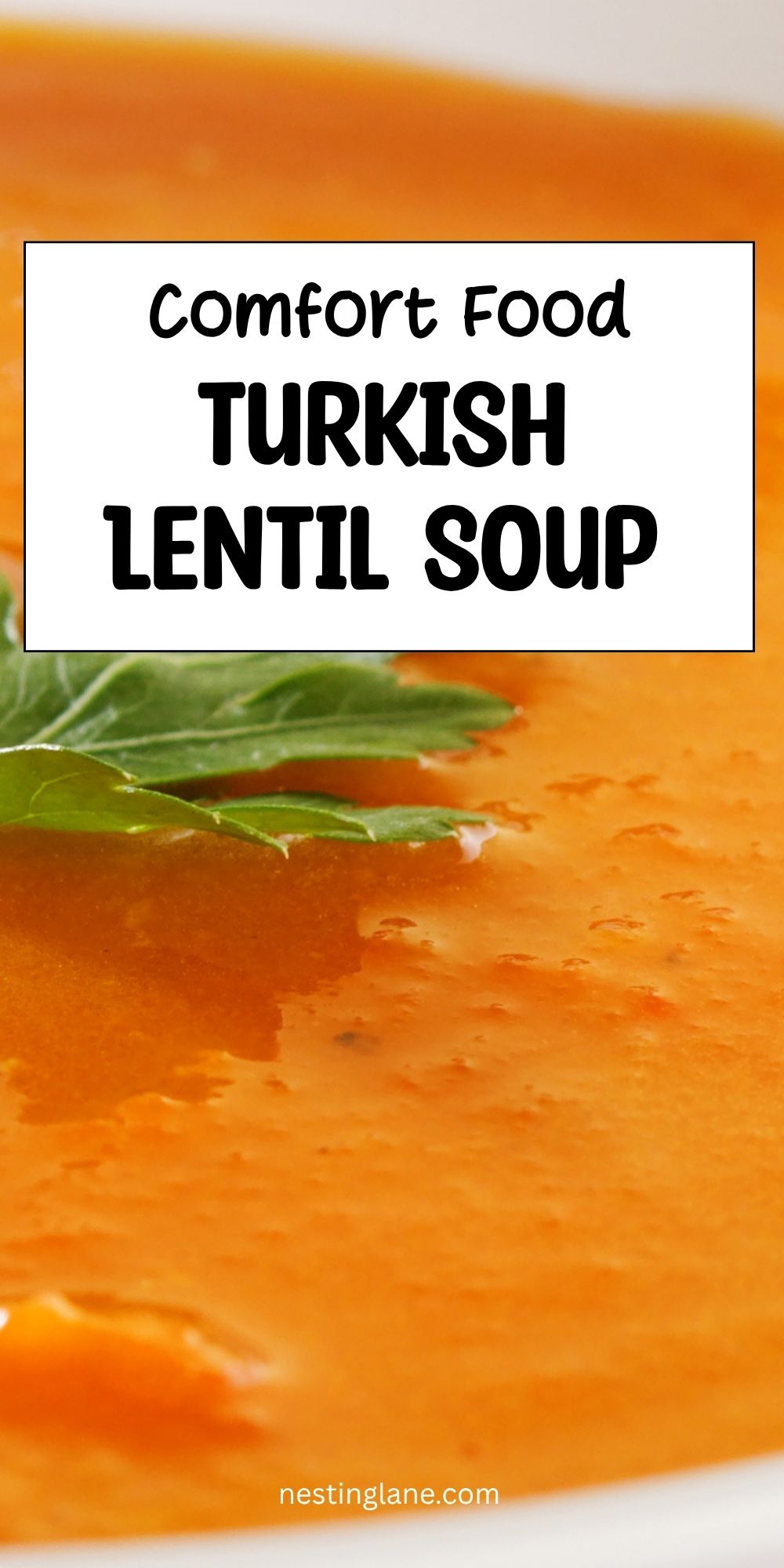 Smooth orange Turkish lentil soup garnished with fresh green herbs. Text reads “Comfort Food Turkish Lentil Soup” and “nestinglane.com.”