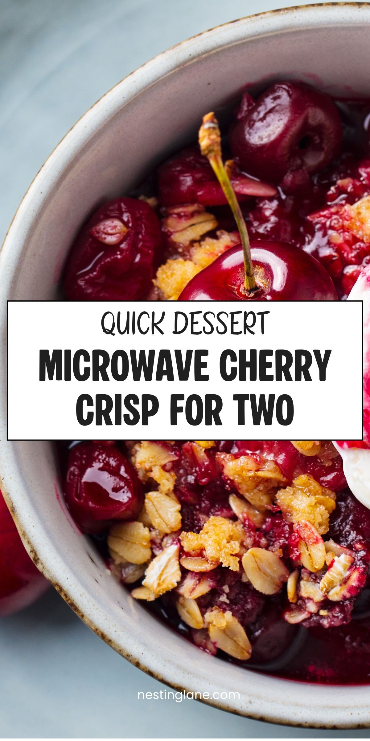 Bowl of warm microwave cherry crisp with glossy cherries, oat crumble, and whipped cream. Text reads βQUICK DESSERT MICROWAVE CHERRY CRISP FOR TWOβ and βnestinglane.com.β