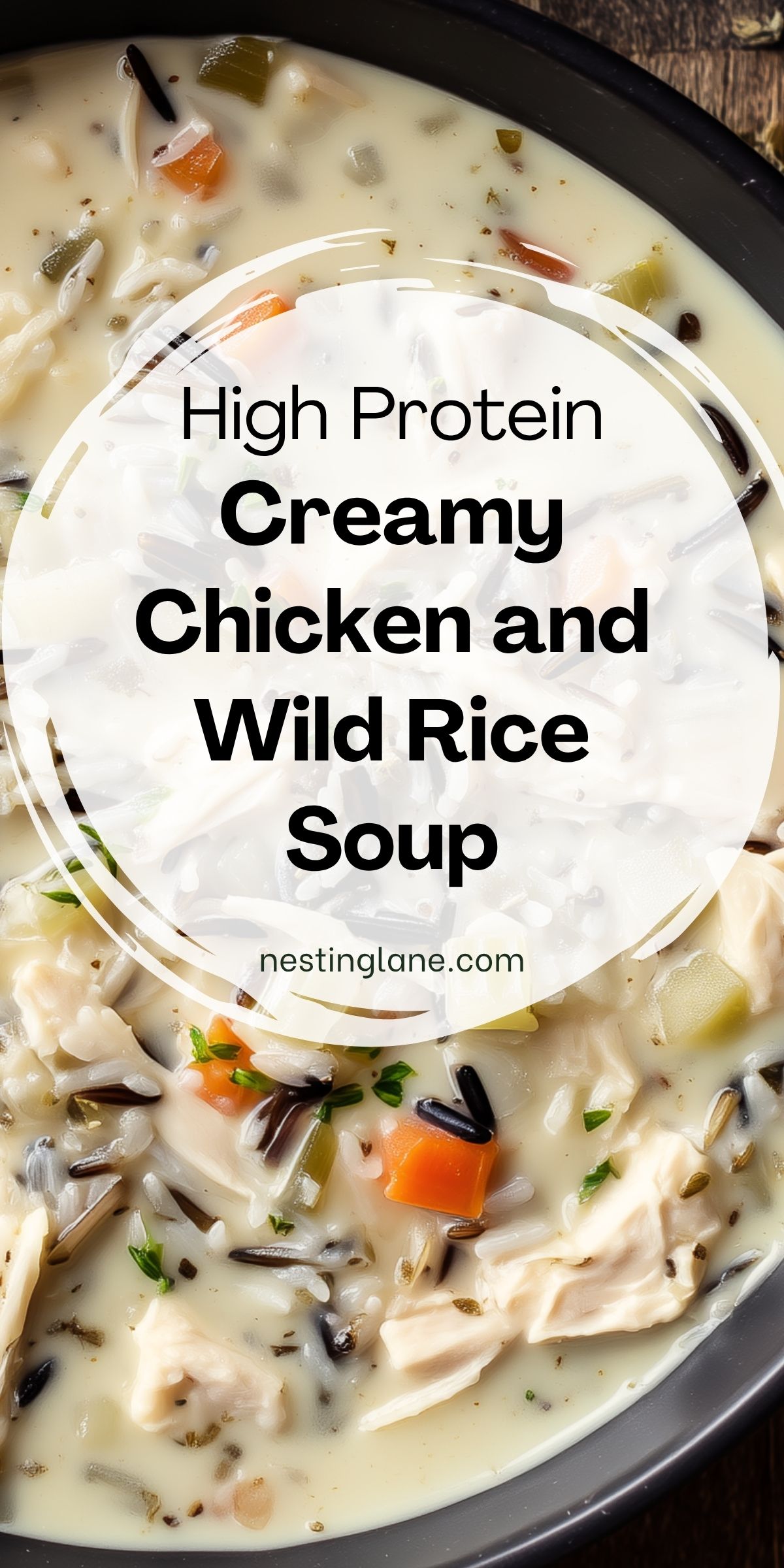 Creamy chicken and wild rice soup with shredded chicken, wild rice, carrots, celery, herbs, and a rich creamy broth. Text reads: “High Protein Creamy Chicken and Wild Rice Soup” and “nestinglane.com.”