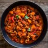 Slow cooker turkey sweet potato chili with ground turkey, black beans, sweet potatoes, tomatoes, red bell peppers, and fresh cilantro.