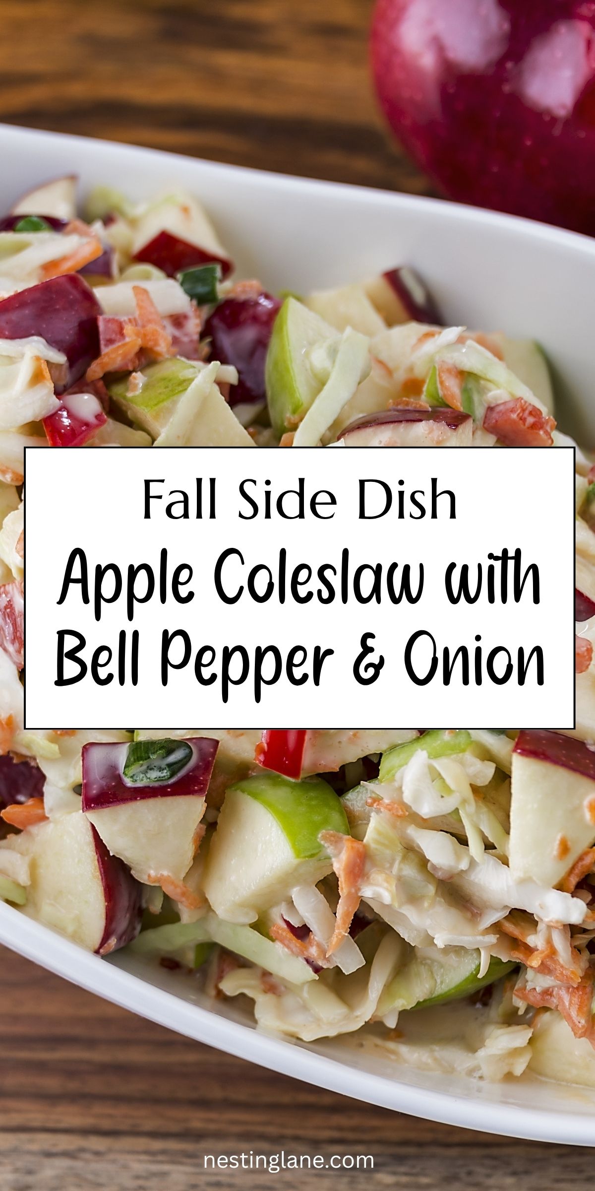 Fall apple coleslaw with chopped red and green apples, shredded cabbage, carrots, red bell pepper, and green onion in a creamy dressing. Text reads: “Fall Side Dish Apple Coleslaw with Bell Pepper & Onion” and “nestinglane.com.”