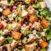 Fall Chicken Chopped Salad with grilled chicken, roasted sweet potatoes, crisp romaine, apples, celery, dried cranberries, pecans, feta cheese, and red onion tossed with creamy dressing.
