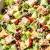 Maple Dijon Chicken Chopped Salad with chicken breast, romaine, crisp apple, cucumber, celery, cheddar cheese, dried cranberries, pecans, and red onion coated in a creamy maple Dijon dressing.