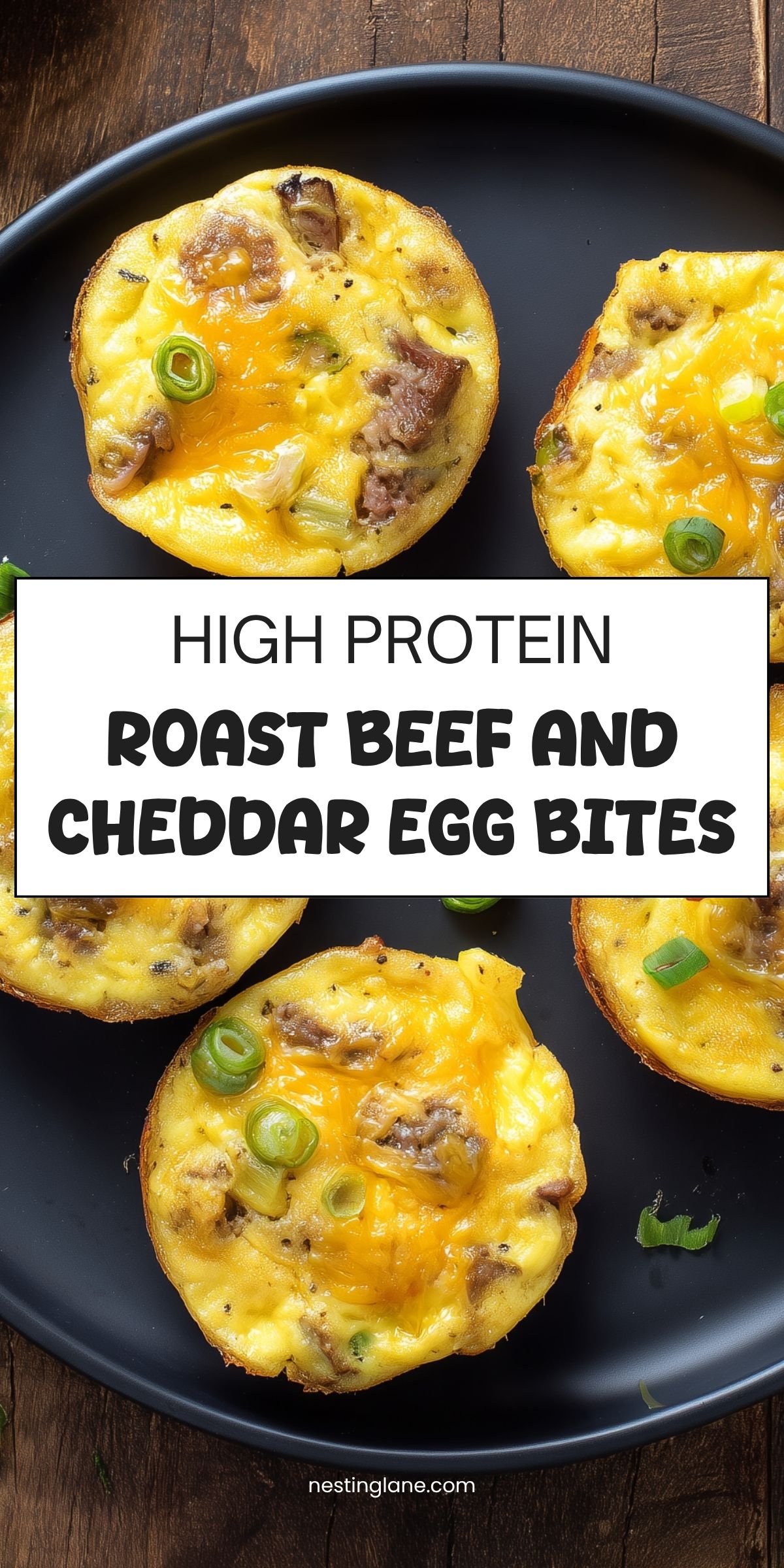 High protein roast beef and cheddar egg bites topped with green onions on a black plate. Text reads: “HIGH PROTEIN ROAST BEEF AND CHEDDAR EGG BITES” and “nestinglane.com.”